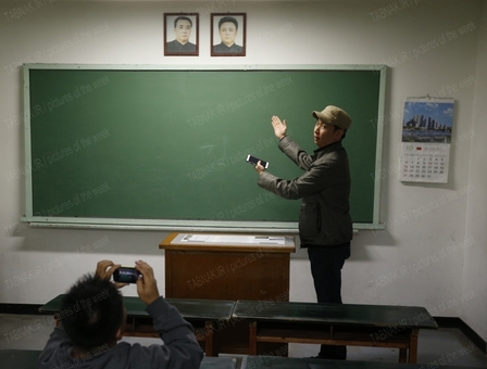 کلاس درسی در پاجو کره شمالی در نزدیکی مرز دو کره. بالای تخته کلاس تصاویر بنیانگذار کره شمالی کیم ایل سونگ و فرزندش کیم جونگ ایل رهبر سابق این کشور به چشم می خورد.
REUTERS/Kim
