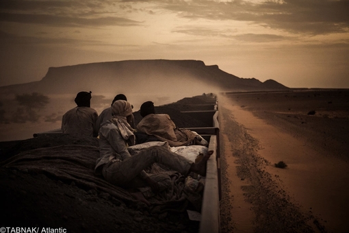 برنده از اسپانیا- معدنچیان نشسته بر واگن حمل سنگ آهن در صحرای موریتانی