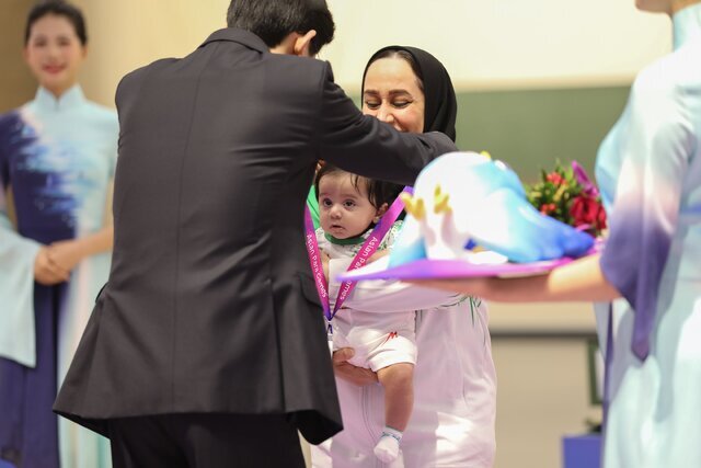 مادر با نوزاد سه ماهه روی سکوی مدال
