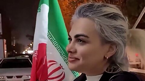 زن بی‌حجاب با پرچم ایران: از دبی برای دفاع آمدم